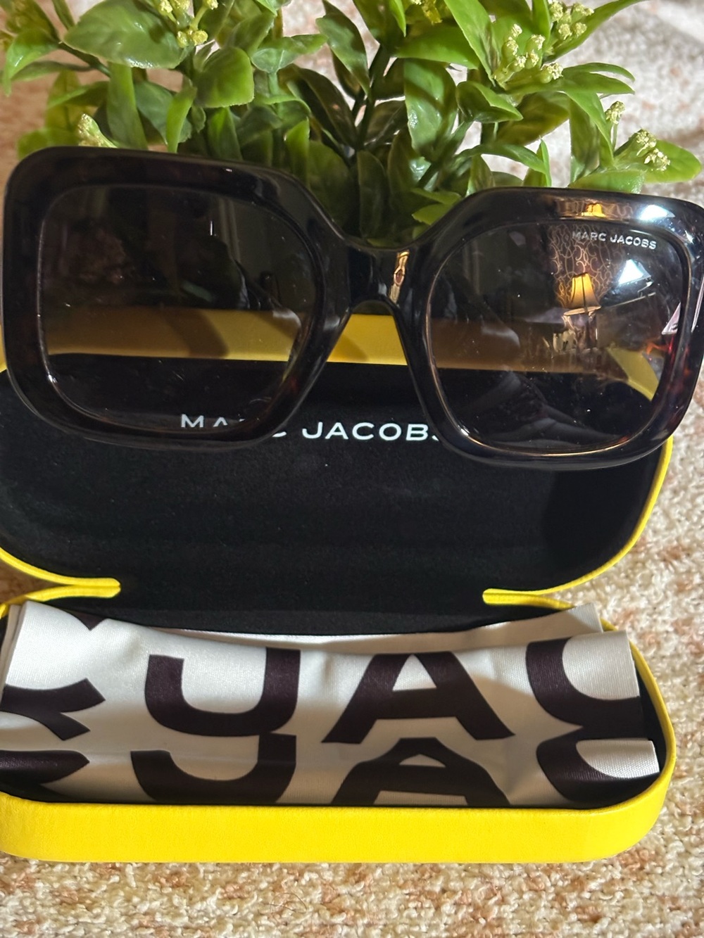 Marc Jacobs Yellow Hard Shell Sunglasses Case with sunglasses inside.